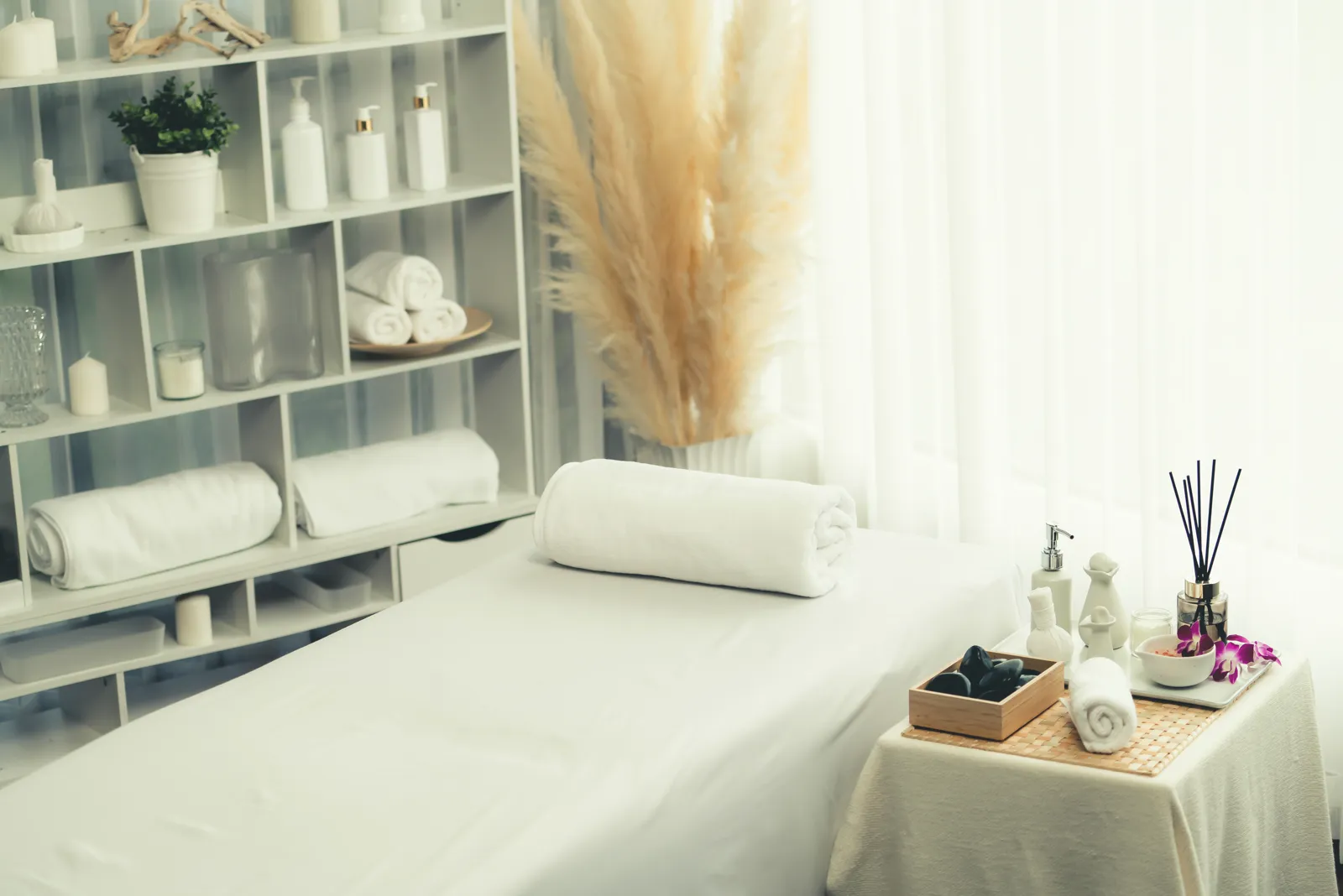 A calm, bright treatment room with fresh towels ready.